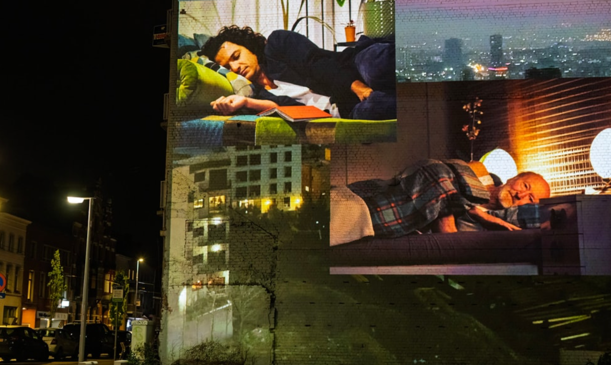 Living Apartment Together projected across an Antwerp apartment façade at night.